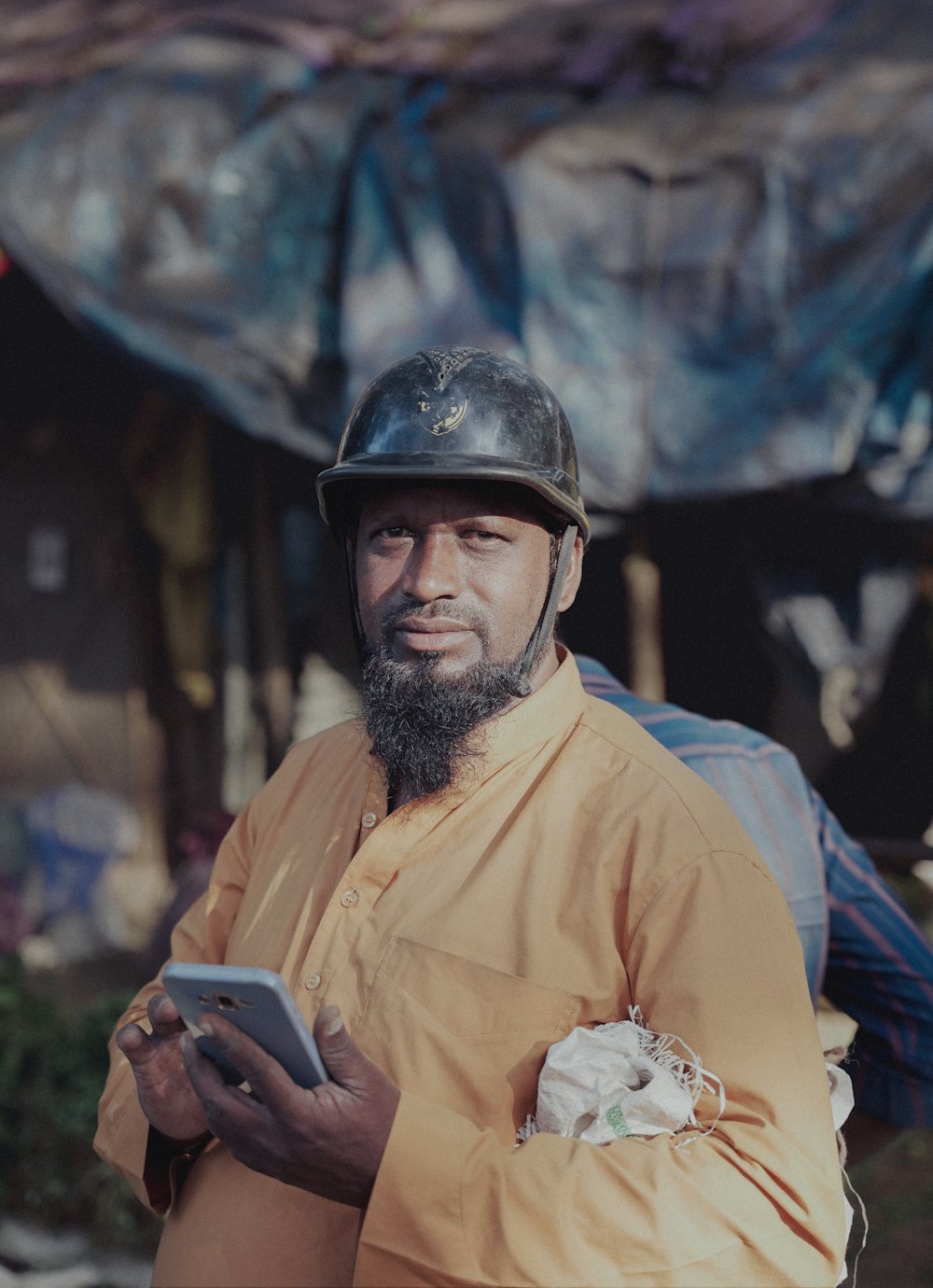 A veteran site worker in a hard hat