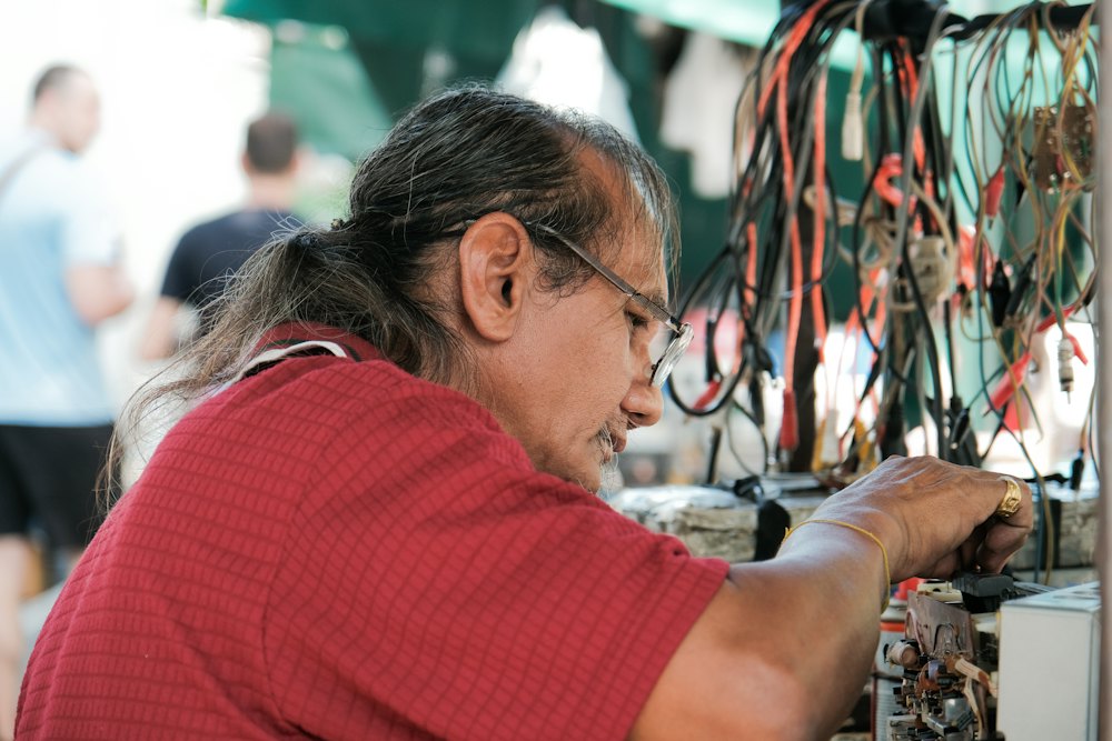 A veteran electrician working on a wiring panel