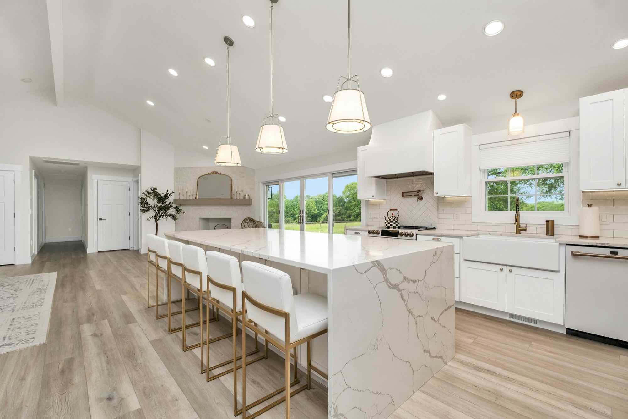 A finished, renovated kitchen with a marble island