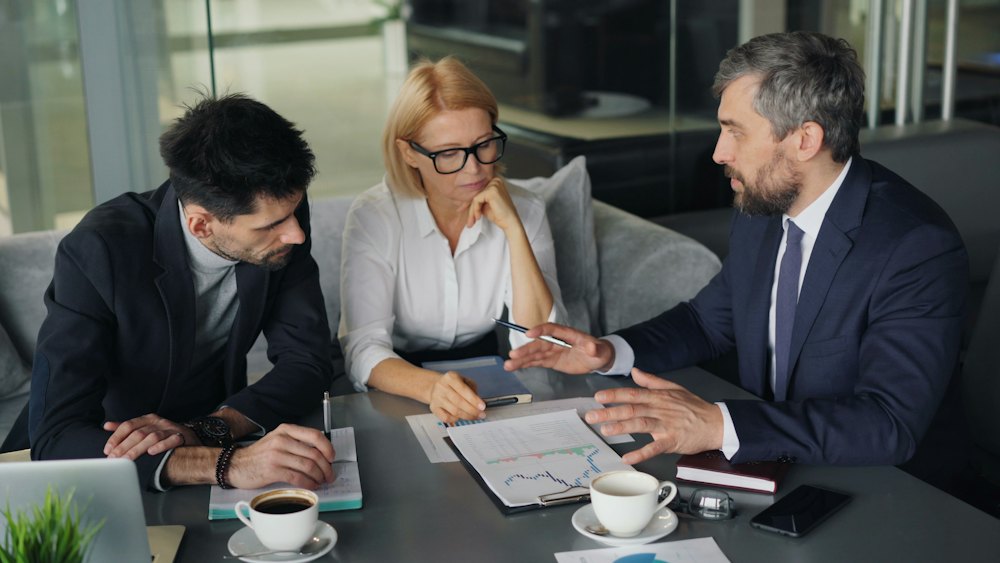 A credit team reviewing a loan file around a table