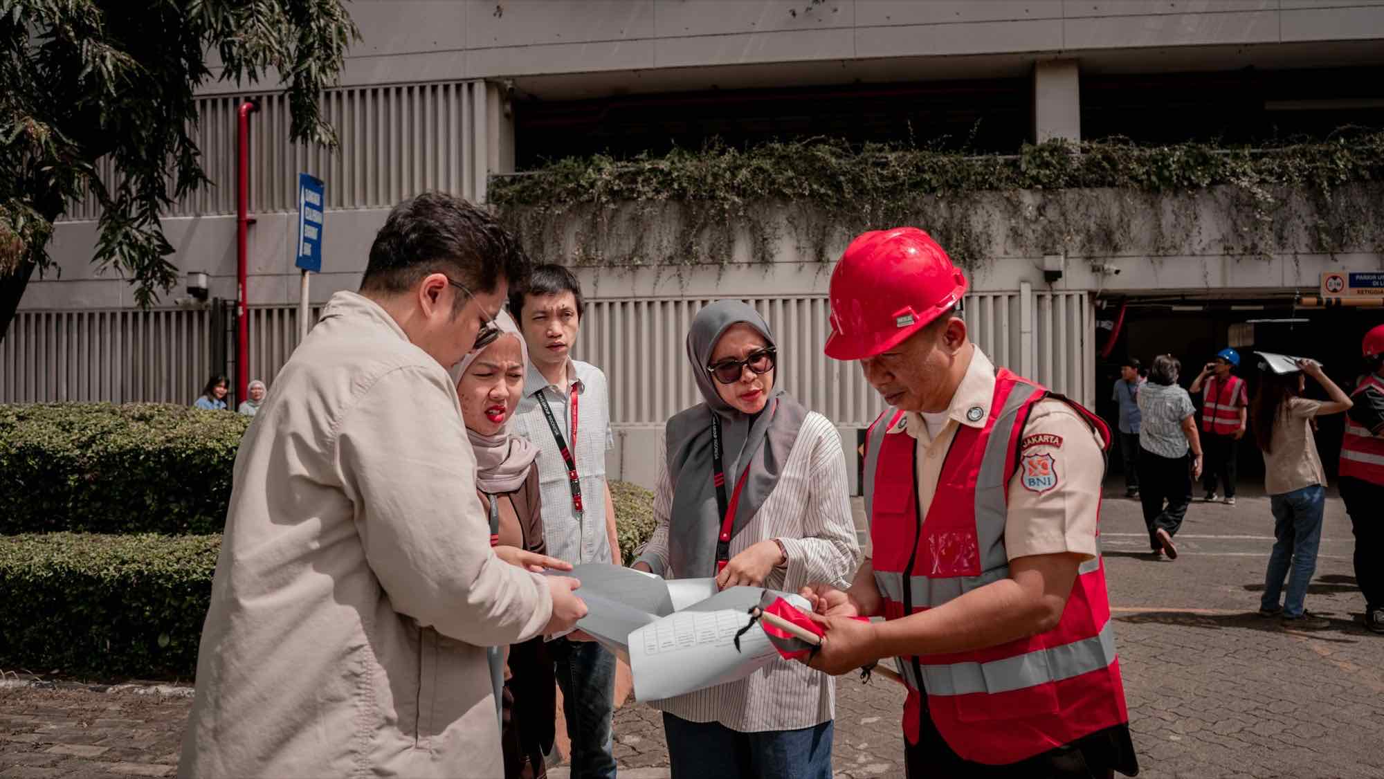 A project team reviewing plans together on site